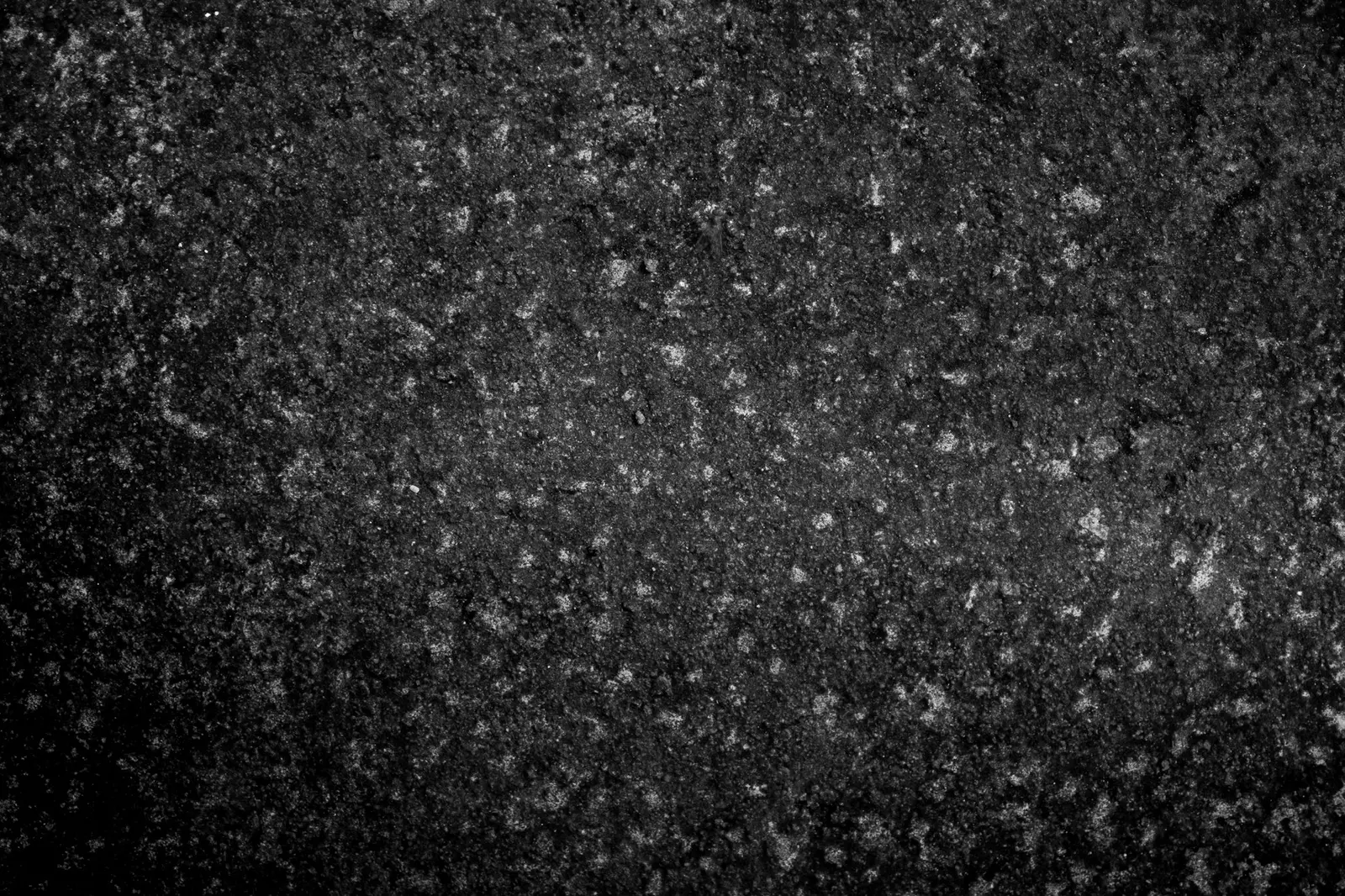 Dark granite surface with light mineral speckles