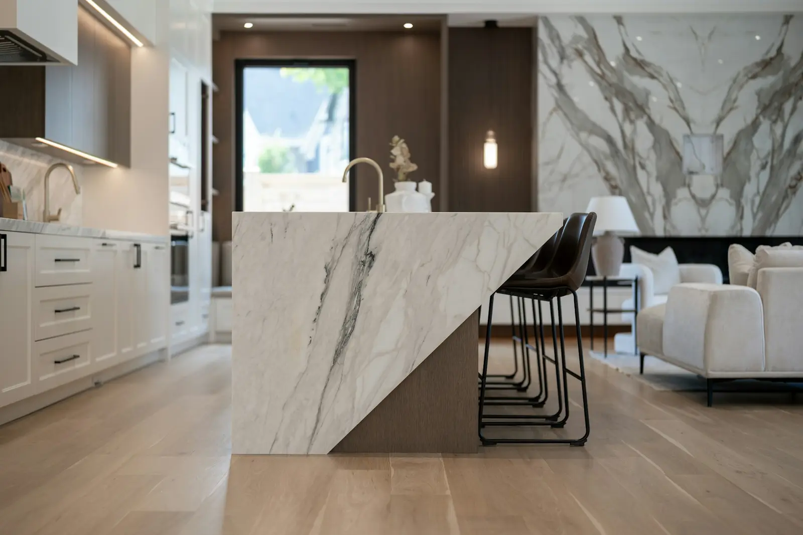 Kitchen with a large marble island and mitered countertop edges