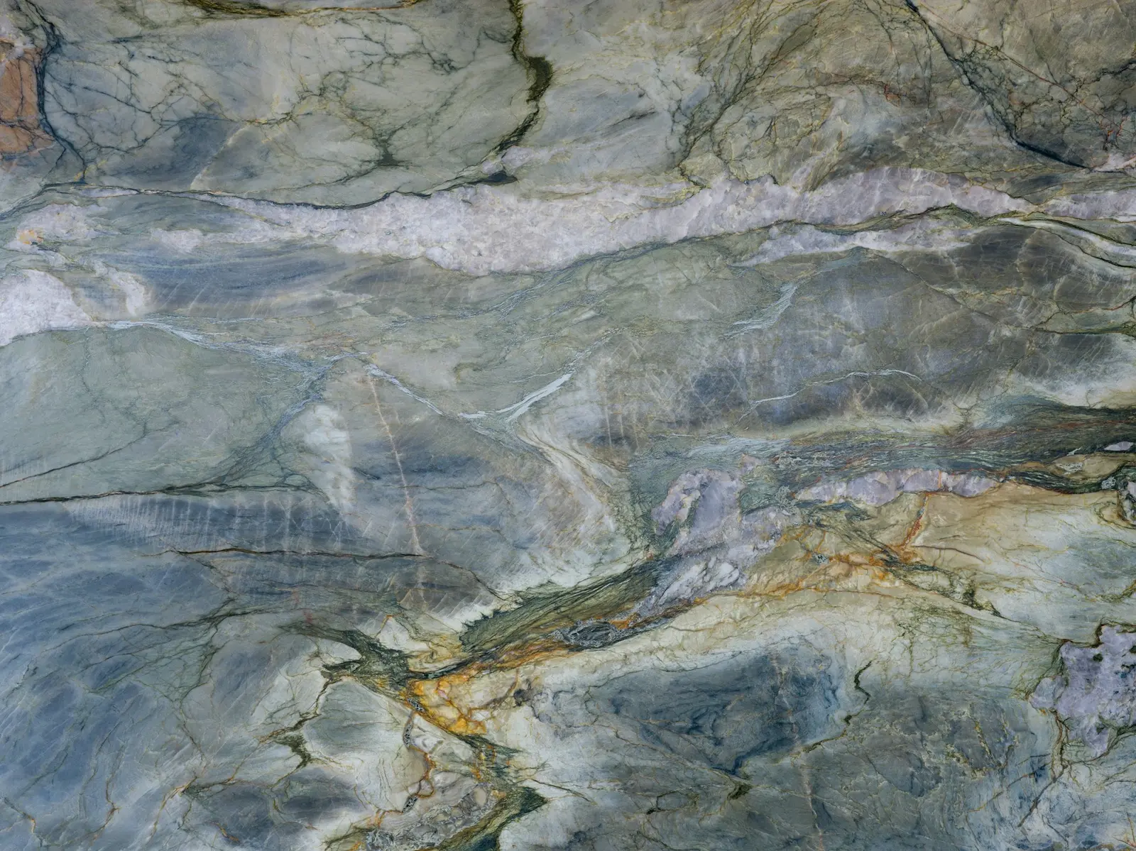Polished stone slab with green and grey veining